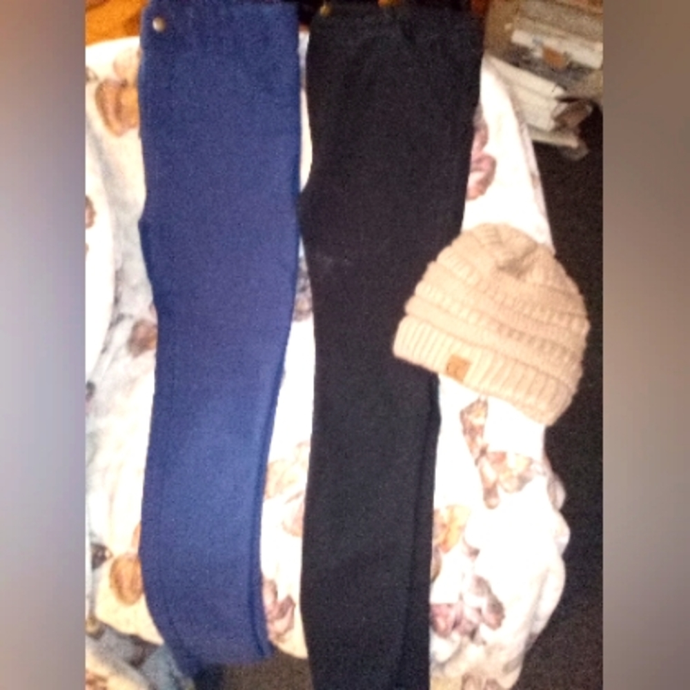 Black and blue jeans and a hat beige